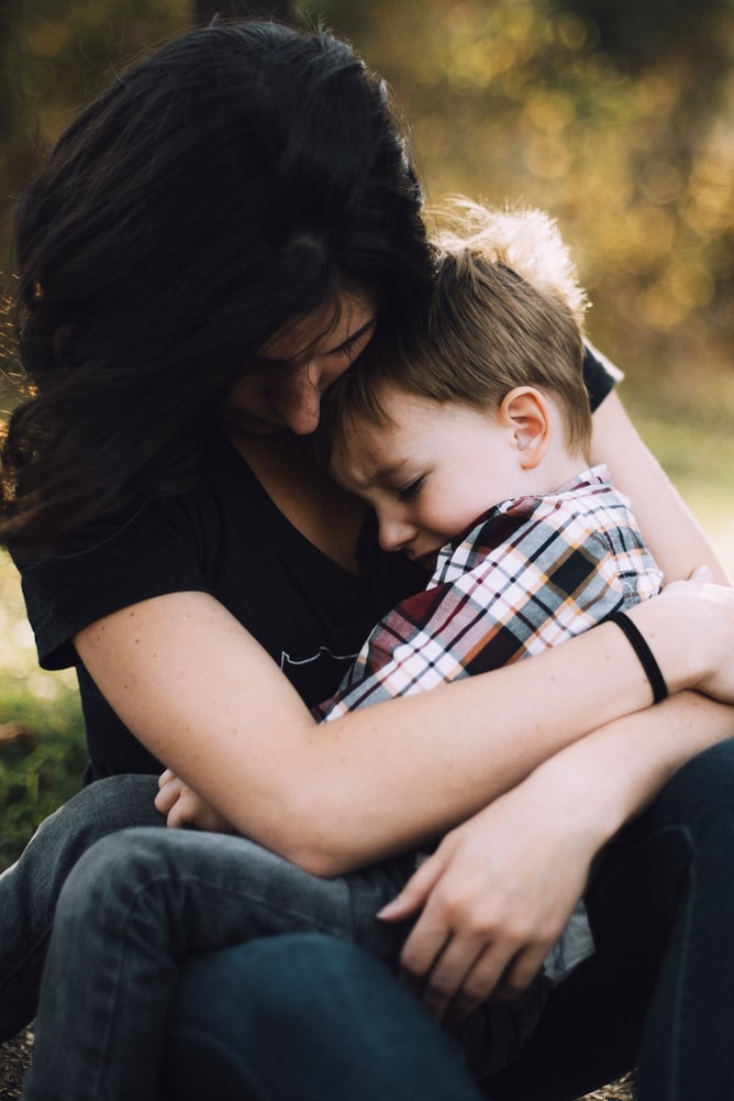 An adult providing comfort and emotional support to a child.